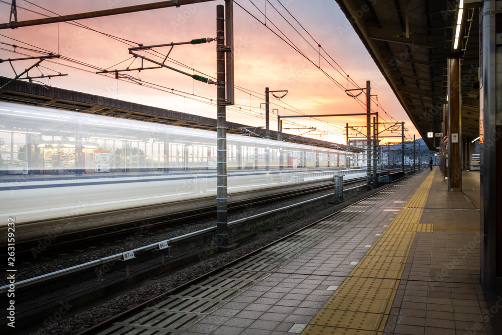 Bullet train japan sunset passing station