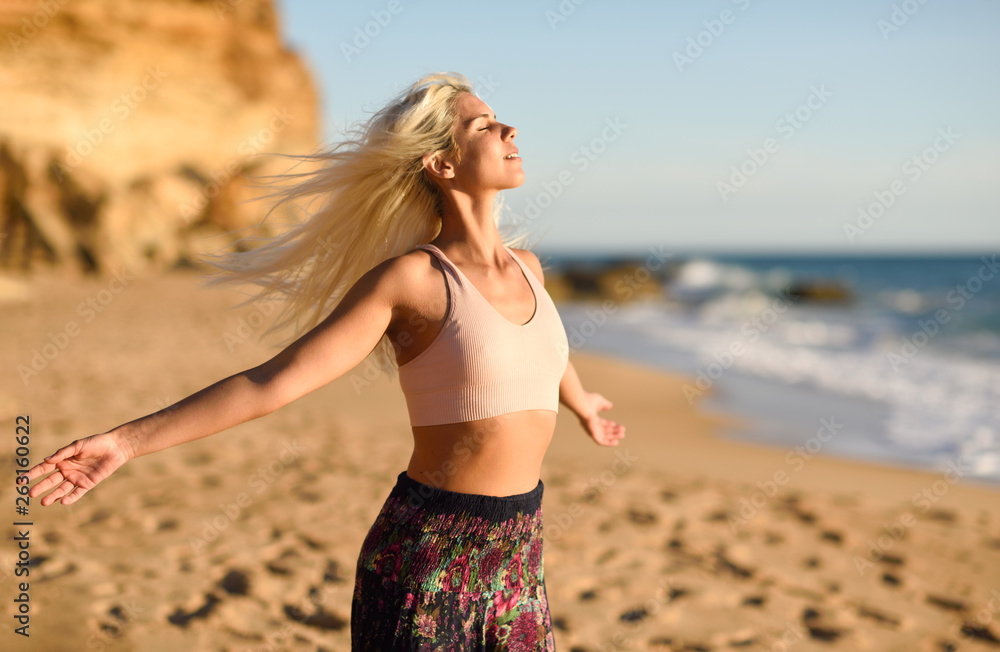 Woman enjoying the sunset on a beautiful beach