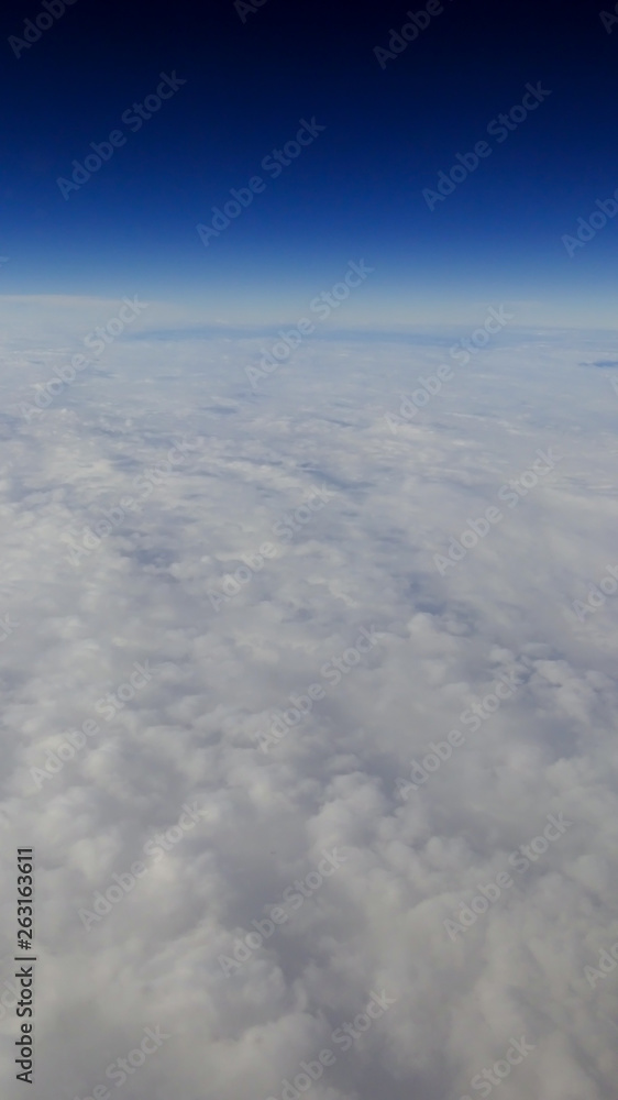 The beautiful cloudscape with clear blue sky. A view from airplane window. The beautiful cloudscape with clear blue sky. A view from airplane window.