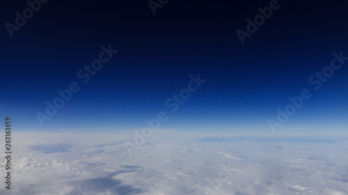 The beautiful cloudscape with clear blue sky. A view from airplane window.