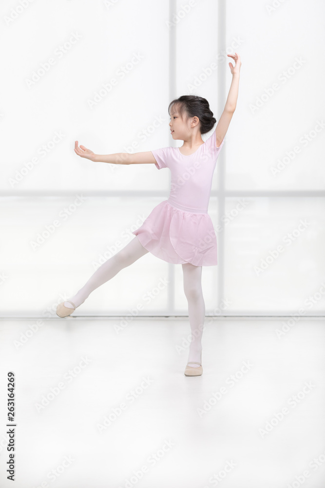 Pink dressed Asian girl in a ballet pose.. Pink dressed Asian girl in a ballet pose..