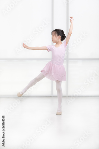 Fototapeta Naklejka Na Ścianę i Meble -  Pink dressed Asian girl in a ballet pose..