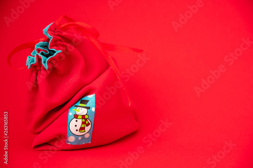Santa Claus red bag on red background. Art soft focus.