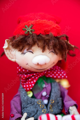 toy rag doll on red background. Art soft focus