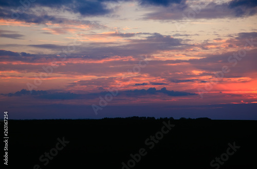 Beautiful sunset. Blurred image of the dramatic sunset in the steppes in the Astrakhan region. Russia. Dramatic clouds as a natural background. © as_trofey