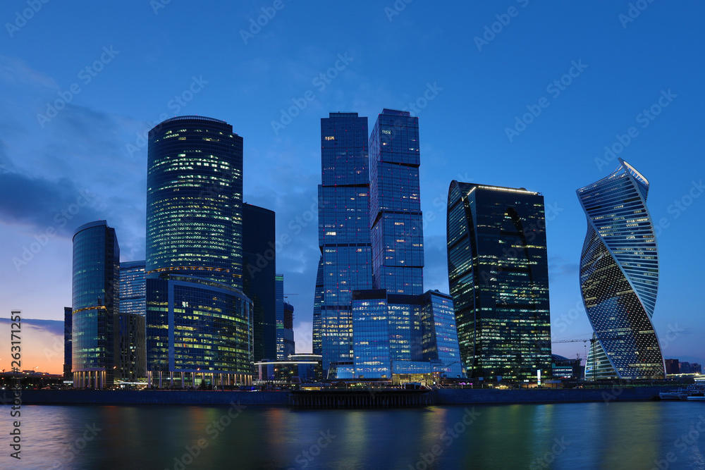 Fototapeta premium Moscow/ Russia April 19 2019: The unique skyscraper of Moscow city, the modern office center in the heart of capital of Russia in the evening in the rays of setting sun on the bank of Moskva river