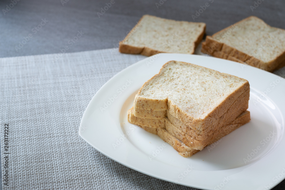 Whole Grain Bread in white dish on concrete table. Whole Grain Bread in white dish on concrete table.