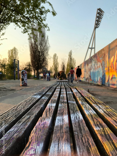 Photography Bench in park  at graffiti wall at Mauerpark in Berlin, Germany