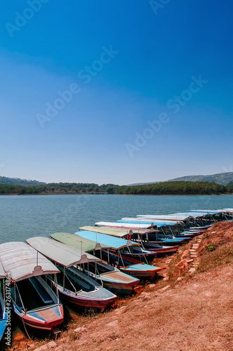 Wooden tourist boats at Tuyen Lam lake or Ho Tuyen Lam in Da Lat - Vietnam with blue sky in spring season