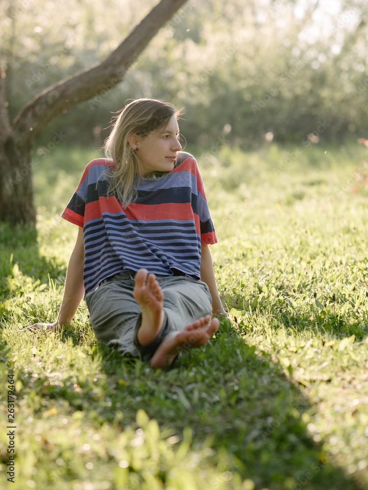 Fototapeta premium Young woman relaxing at garden