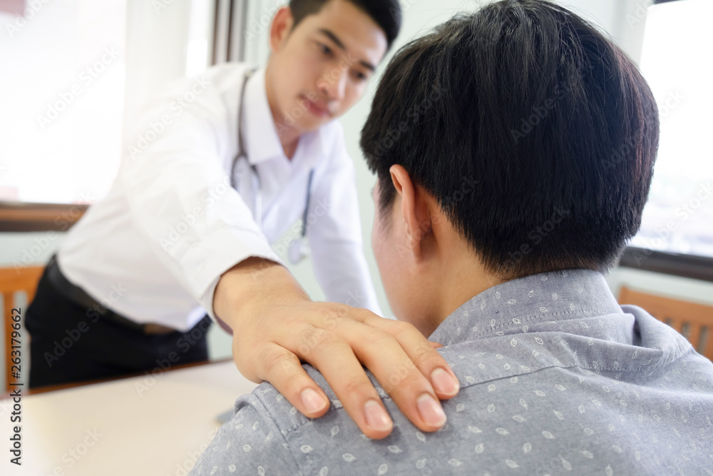 Doctor comforting patient at consulting room. Doctor comforting patient at consulting room.