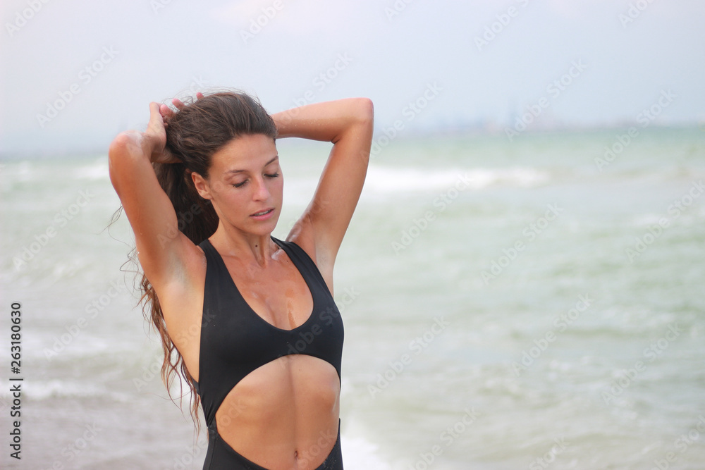 Woman on the beach enjoying the summer by the sea Woman on the beach enjoying the summer by the sea