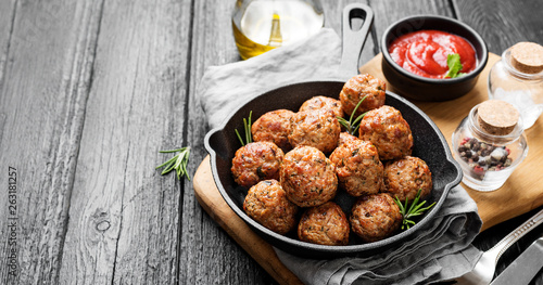 Meatballs served with tomato sauce in frying pan . photo