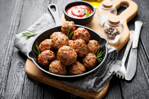Meatballs served with tomato sauce in frying pan . photo