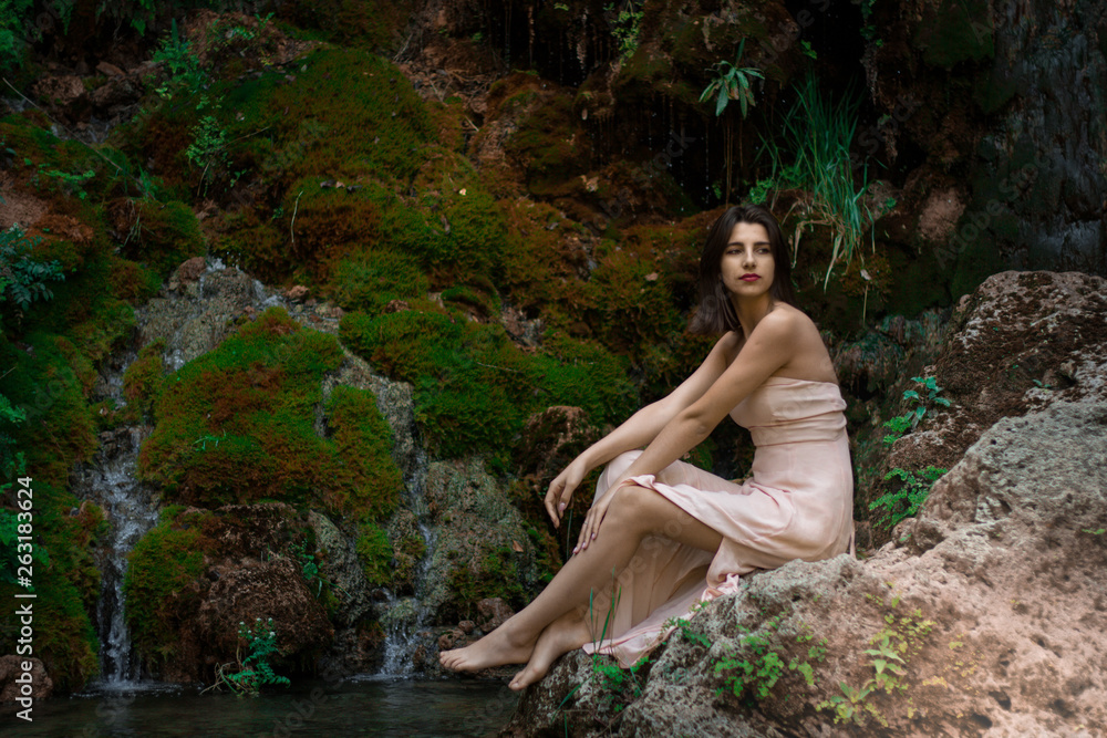 Beautiful sexy woman among green tropical plants. Beauty, fashion. Spa, healthcare. Tropical vacation