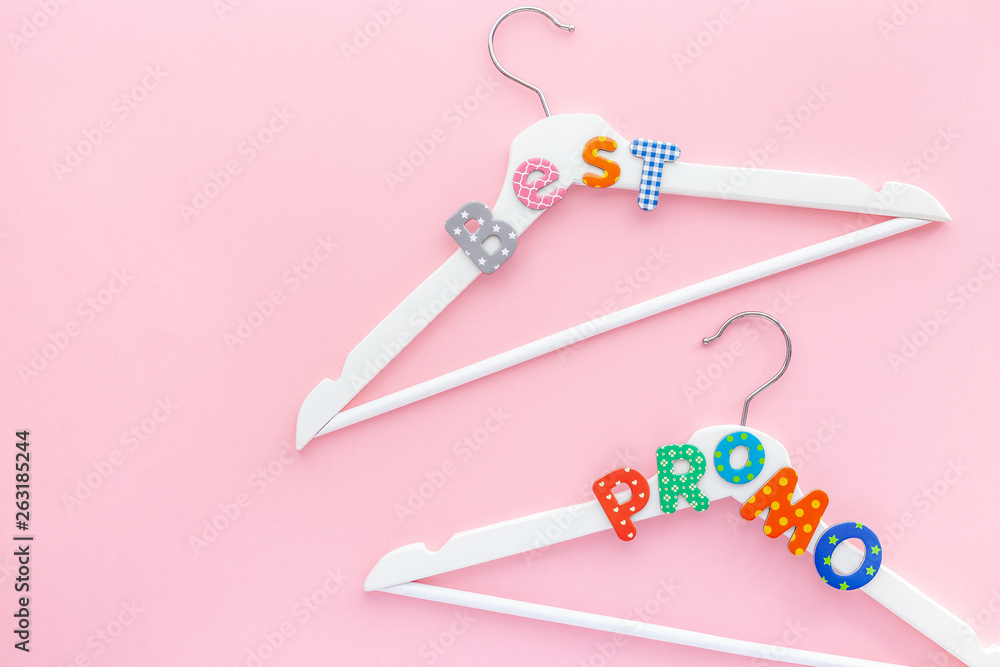 White hangers with sale text on pink background White hangers with sale text on pink background