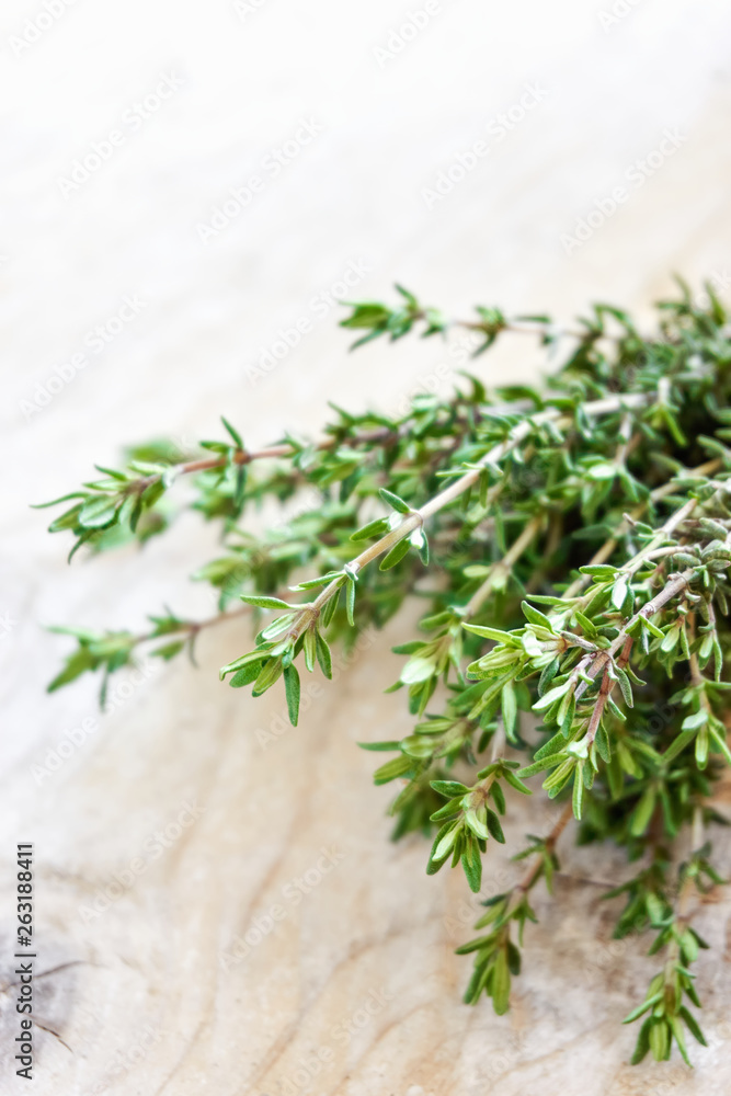 Closeup of a bunch of fresh aromatic green thyme herb on old wood background with copy space. Vertical image. Closeup of a bunch of fresh aromatic green thyme herb on old wood background with copy space. Vertical image.