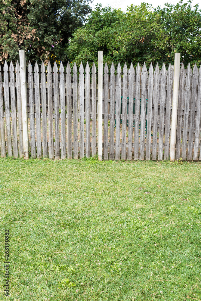 Wooden picket fence in the meadow Wooden picket fence in the meadow