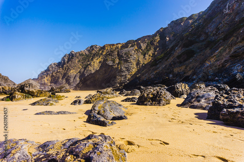 Stones and rocks on sandy beach in Portugal the west Atlantic photo