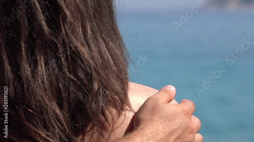 Summer holiday, man hand caressing woman shoulders
