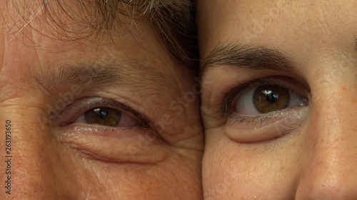 Close up portrait of mother and daughter eyes, smile between generations