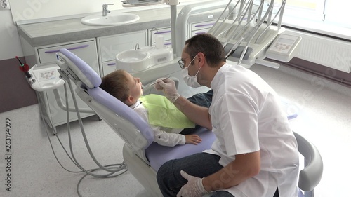 Young doctor consulting little child  portrait of friendly dentist and cute kid