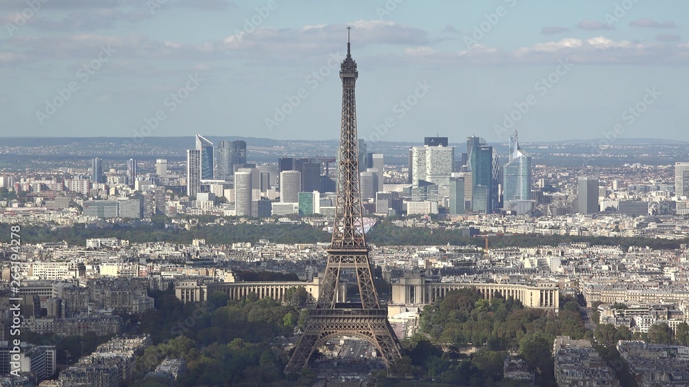 Timelapse clouds shadows movong fast over the Eiffel tower and buildings of Paris city