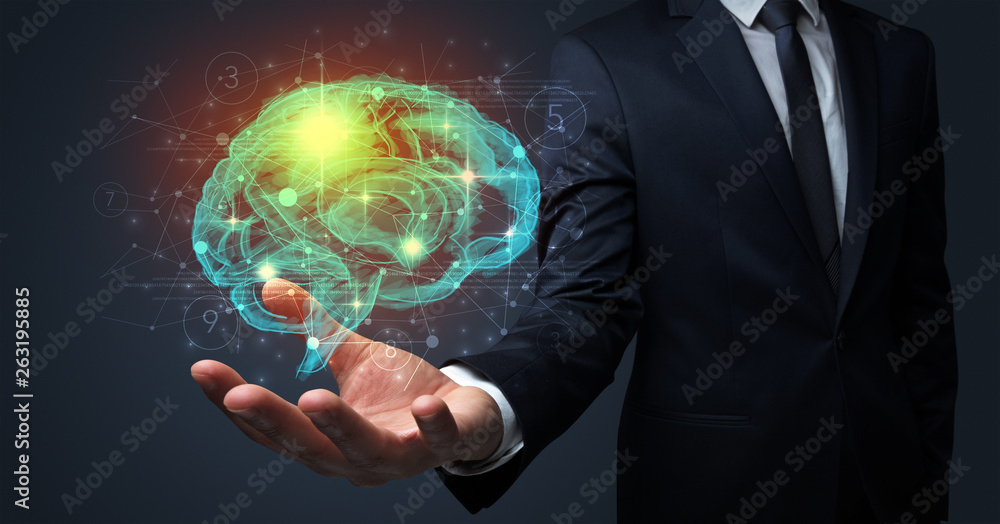 Businessman holding human brain on his hand with logistics symbols around Businessman holding human brain on his hand with logistics symbols around