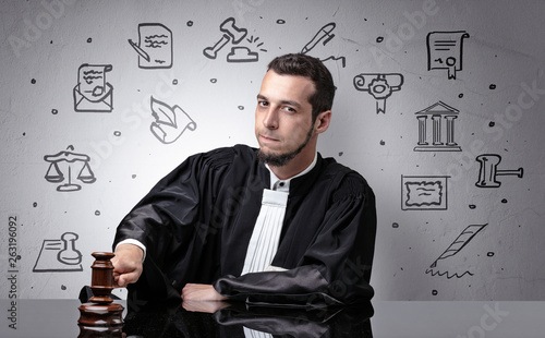 Handsome judge with court symbols around photo