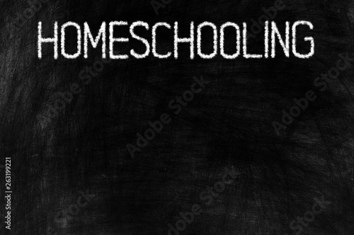 Homeschooling in Chalk Writing on the Top of Old Grunge Chalkboard Background, Suitable for Education Concept.