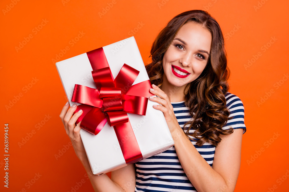 Close up photo beautiful she her lady arms big large giftbox best guest family meeting red lips pomade excited funky wear casual striped white blue t-shirt clothes isolated orange bright background Close up photo beautiful she her lady arms big large giftbox best guest family meeting red lips pomade excited funky wear casual striped white blue t-shirt clothes isolated orange bright background