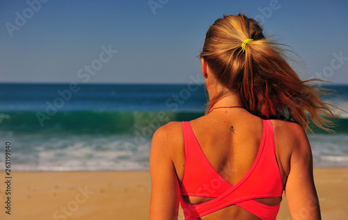 Blond woman standing at sea