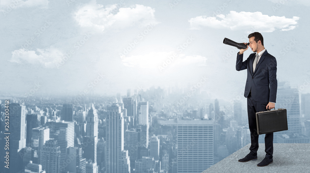 Businessman looking forward to a city with binoculars from skyscraper concept
Businessman looking forward to a city with binoculars from skyscraper concept