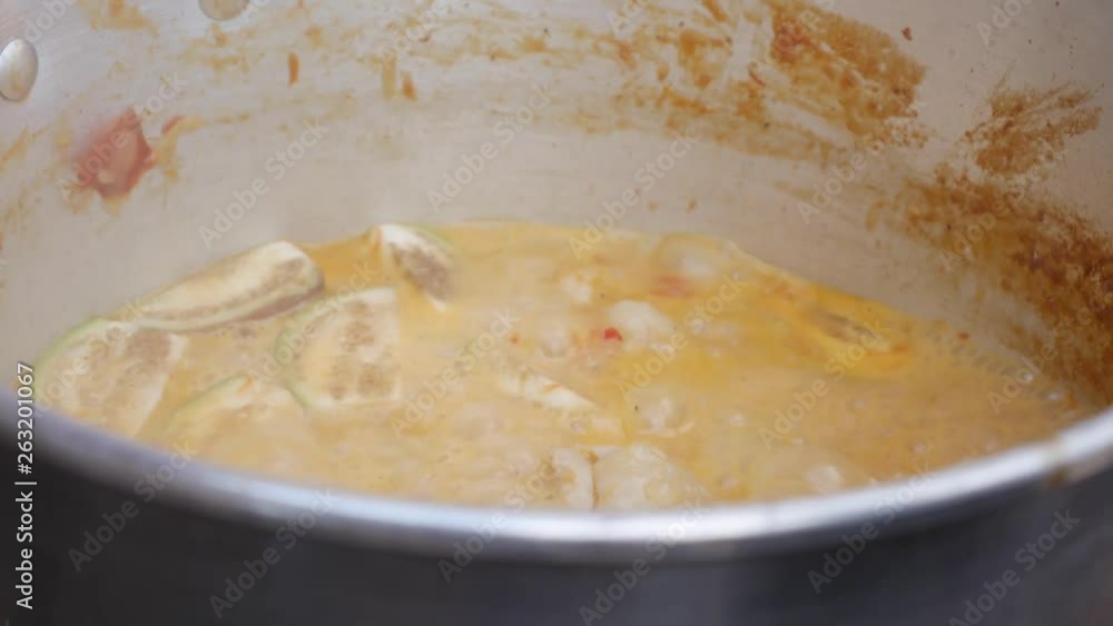 Pan of boiling spicy Thai soup with chicken and shrimps. Step by step cooking tom yam soup. Thai cuisine. Closeup. 4k Pan of boiling spicy Thai soup with chicken and shrimps. Step by step cooking tom yam soup. Thai cuisine. Closeup. 4k