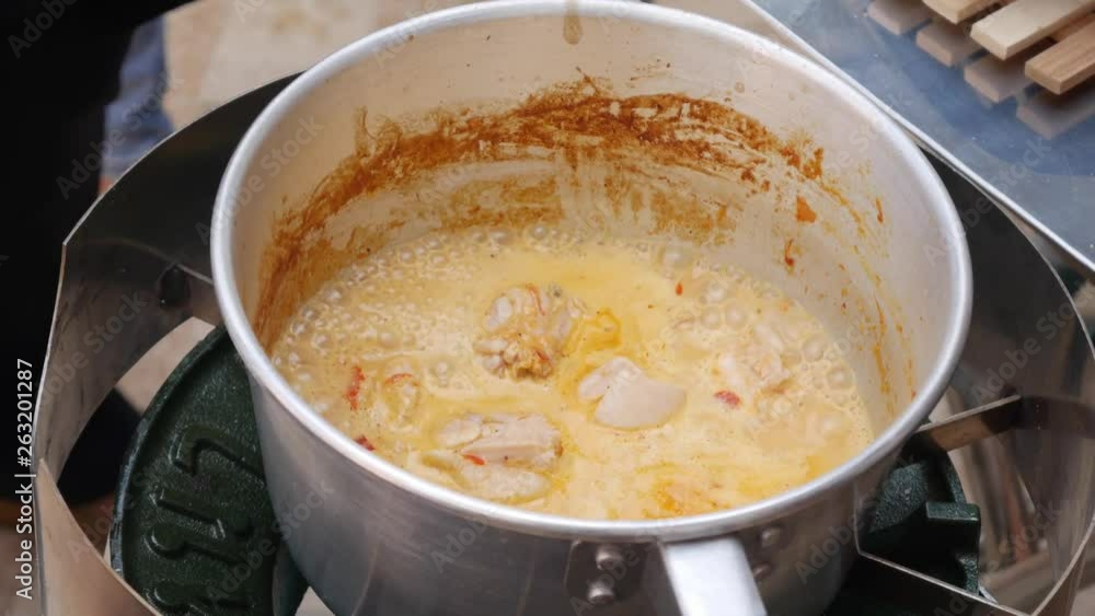 Step by step cooking tom yam soup. Chicken fillet added to boiling coconut milk with chili paste. Thai cuisine. Closeup. 4k Step by step cooking tom yam soup. Chicken fillet added to boiling coconut milk with chili paste. Thai cuisine. Closeup. 4k