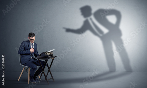 Little man working and a big shadow arguing with him  © ra2 studio
