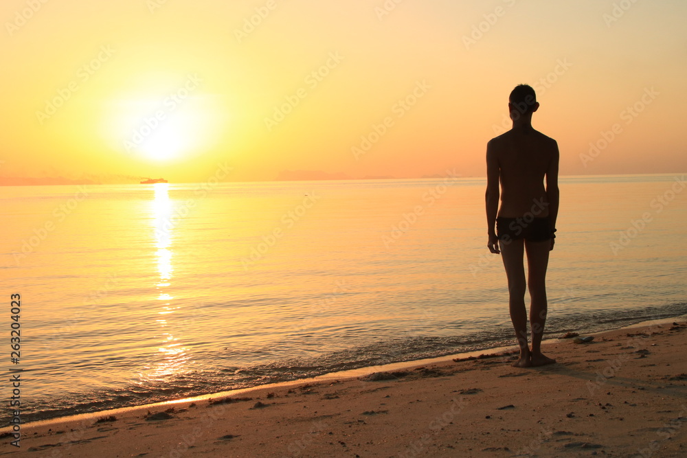 man walking on the beach at sunset man walking on the beach at sunset