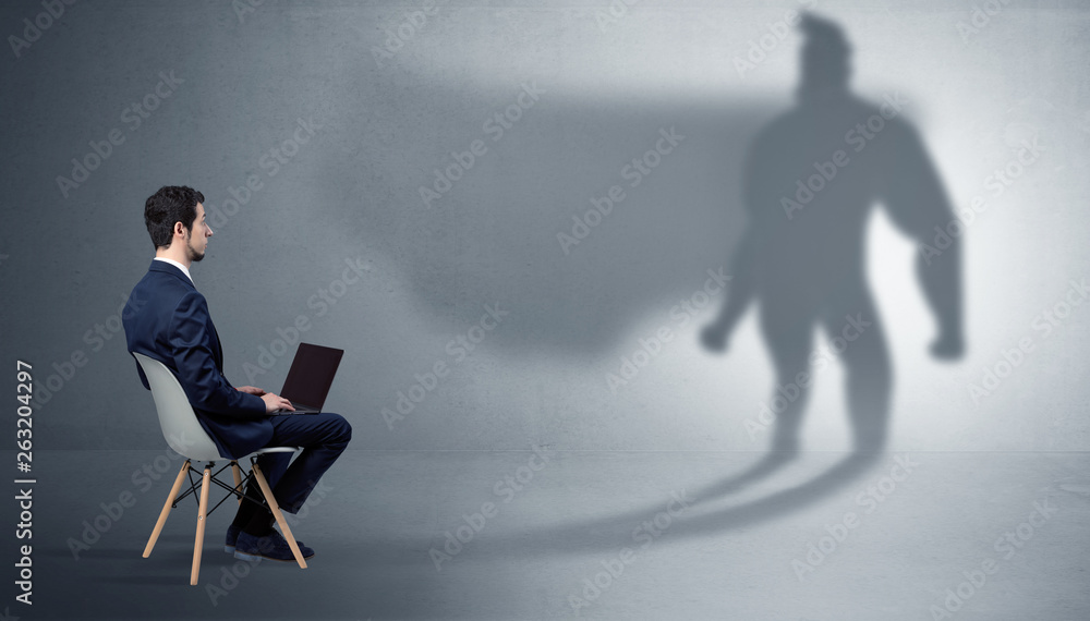 Humble businessman staying and offering stuffs to a superhero shadow
Humble businessman staying and offering stuffs to a superhero shadow