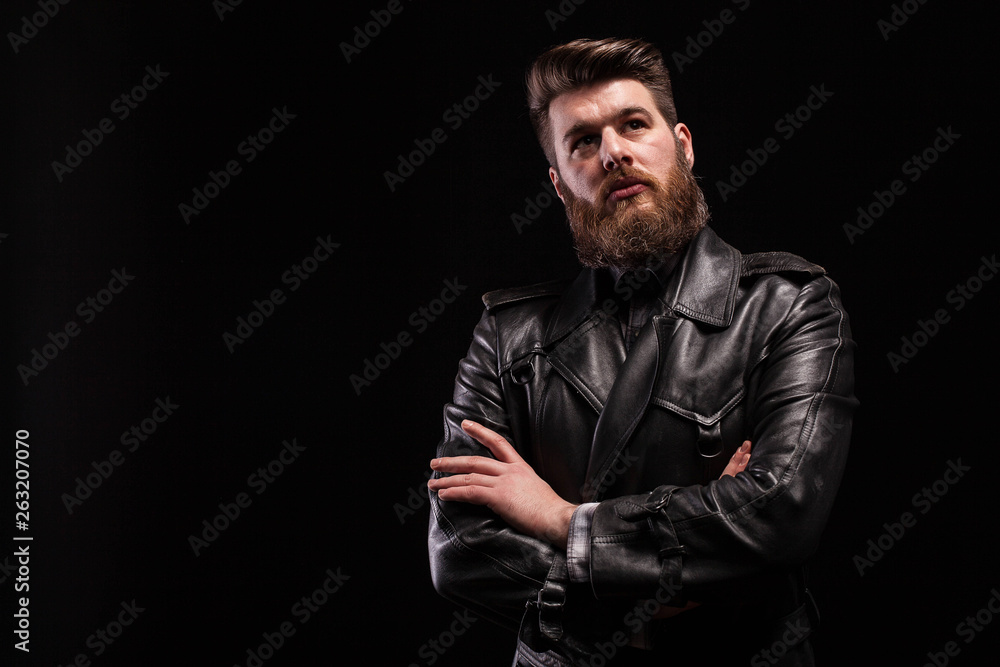 Attractive bearded man keeping his arms crossed over blac background - obrazy, fototapety, plakaty 