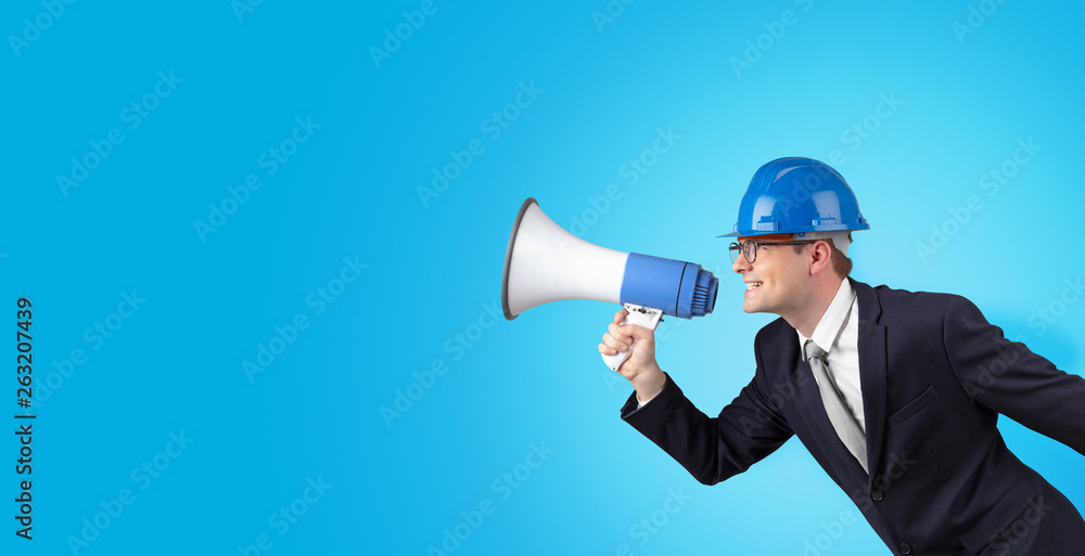 Young architect constructor yelling with megaphone and copyspace Young architect constructor yelling with megaphone and copyspace