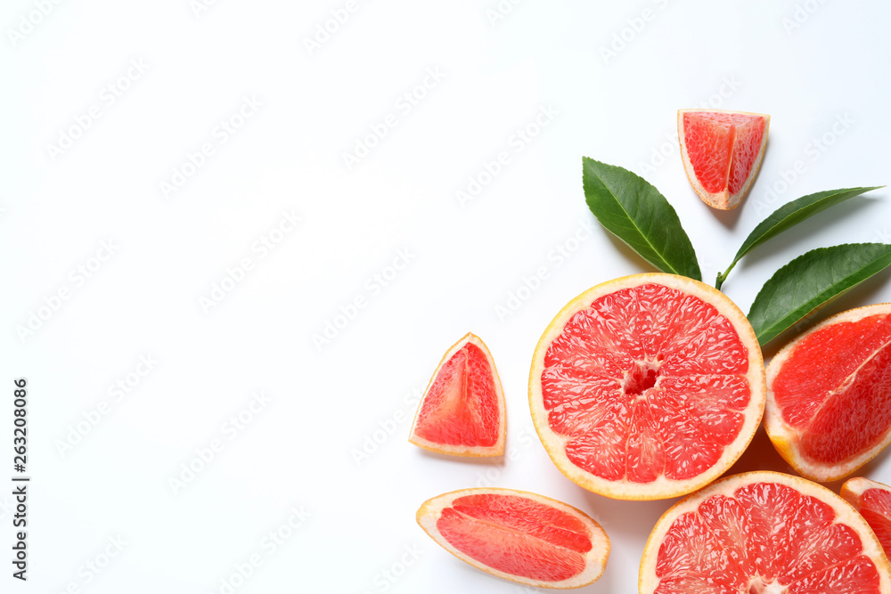 Grapefruits and leaves on white background, top view. Citrus fruits Grapefruits and leaves on white background, top view. Citrus fruits