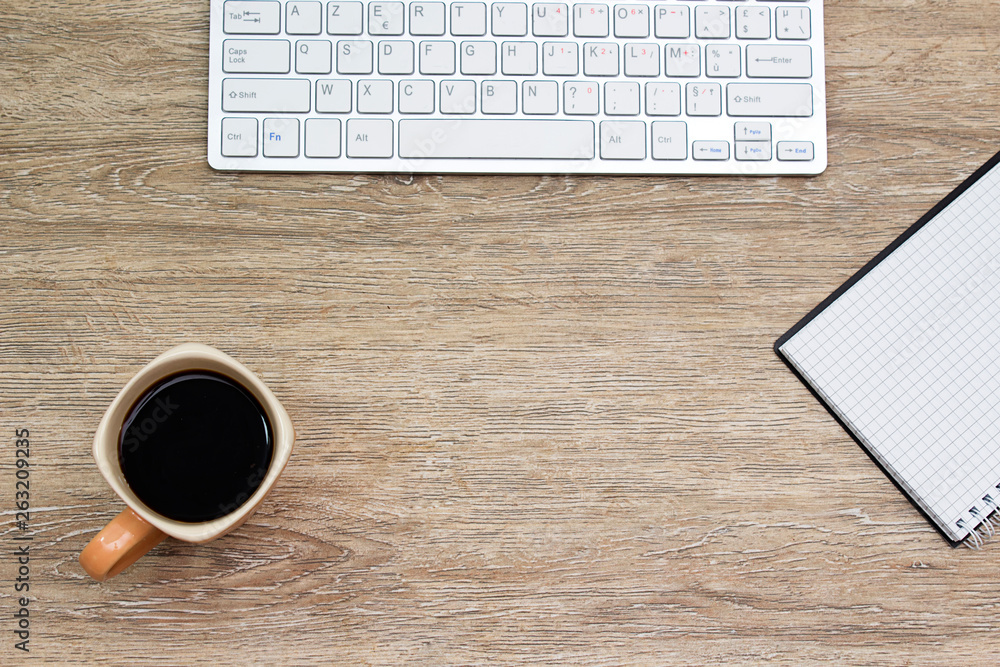 keyboard, coffee cup a,d notepad on wooden table keyboard, coffee cup a,d notepad on wooden table