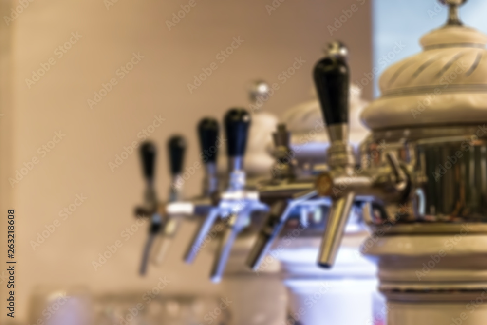 Blurred image for background of beer tap in row at restaurant or pub. Blurred image for background of beer tap in row at restaurant or pub.