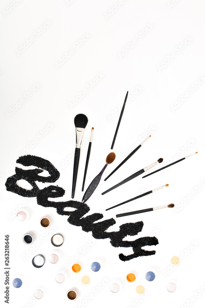 Glamour set of makeup stuff isolated on white background. Black inscription Beauty , brushes, paints, colors, stylist, creative work, design, idea, cosmetic luxury visage Glamour set of makeup stuff isolated on white background. Black inscription Beauty , brushes, paints, colors, stylist, creative work, design, idea, cosmetic luxury visage