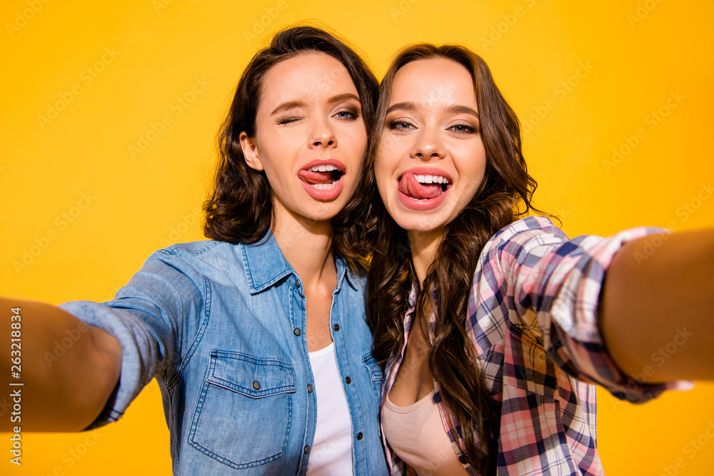 Close up photo funny carefree careless childish playful teen fool make photos travel summer beautiful excited enjoy positive cheerful satisfied content  isolated checked jeans shirts yellow background