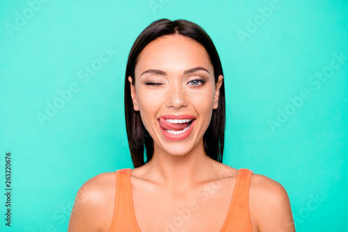 Closeup photo portrait of cheerful charming nice glad romantic ambitious she her lady showing tongue isolated pastel background
