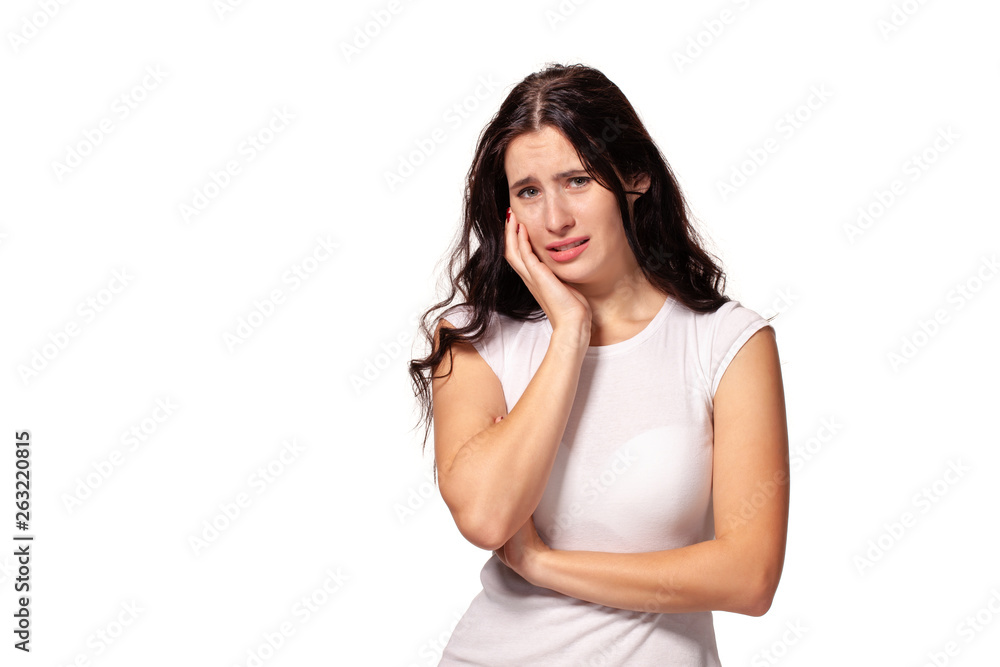 Beautiful and unhappy young woman with dark wavy hair with serious expression on her face. Beautiful and unhappy young woman with dark wavy hair with serious expression on her face.