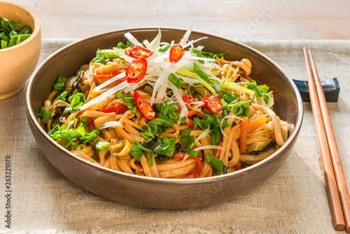 Traditional chinese vegetarian noodle chow mein on a plate with chopsticks