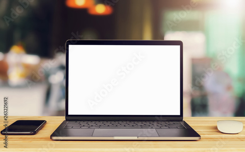 laptop computer blank white screen and mobile on table in cafe background