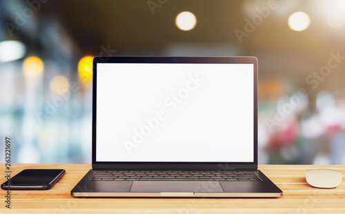laptop computer blank white screen and mobile on table in cafe background
